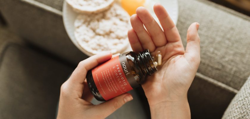 person holding red bottle