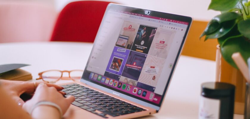 a-woman-sitting-at-a-table-using-a-laptop-computer