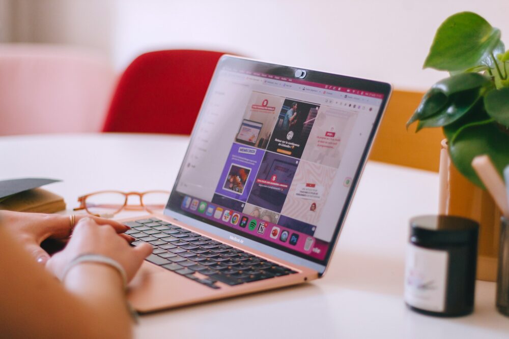 a-woman-sitting-at-a-table-using-a-laptop-computer
